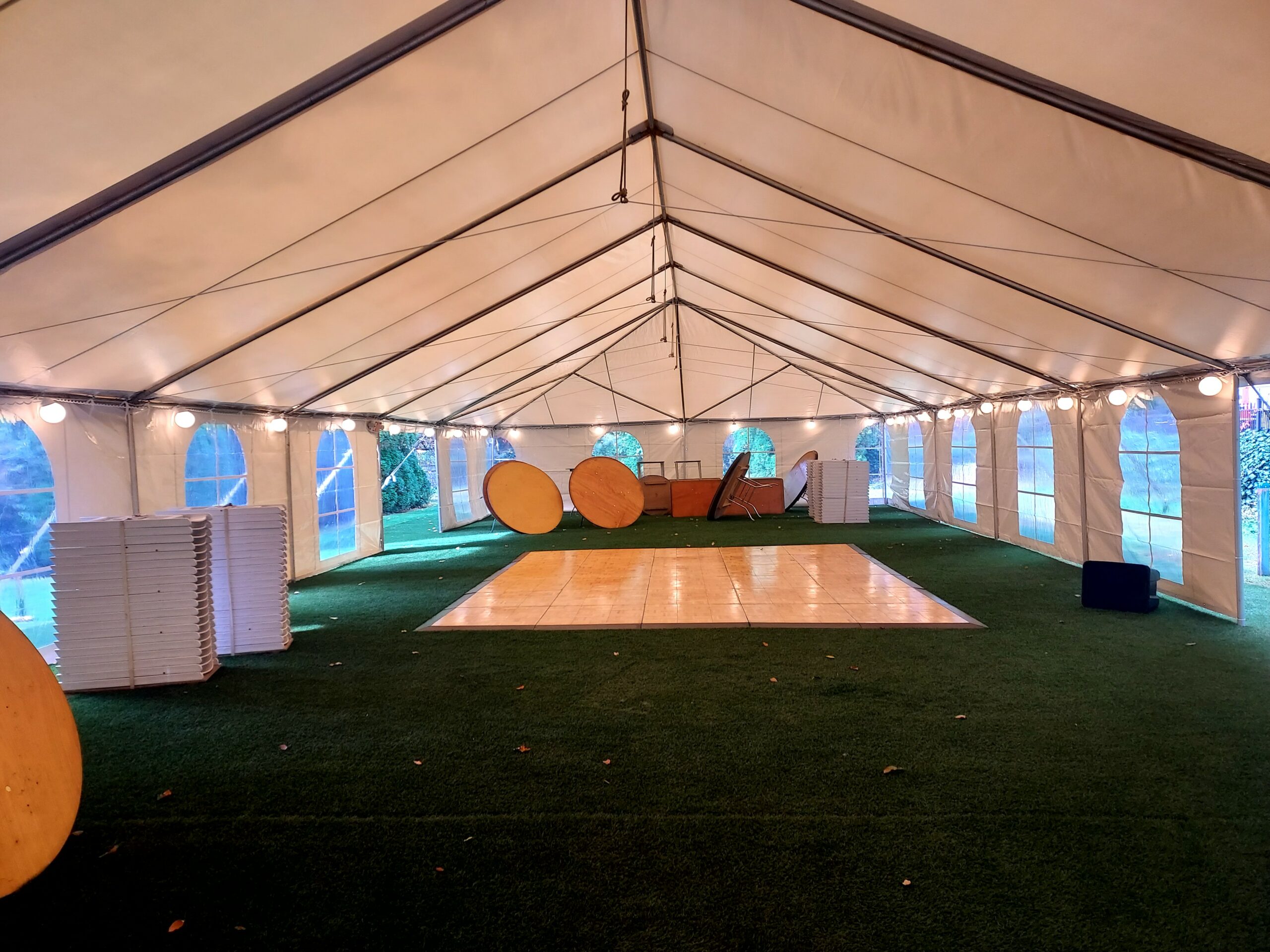 Tables and dance floor being set for an event